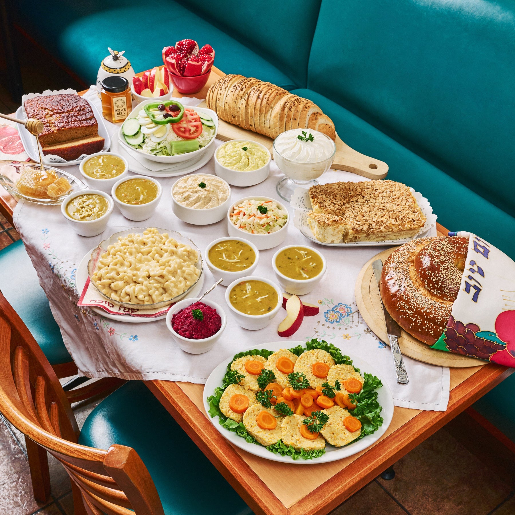 A Feast for Rosh Hashanah with Gefilte fish, mac and cheese, challah, pudding, honey cake, rye bread. From United Bakers on a set table in their rear dining room.