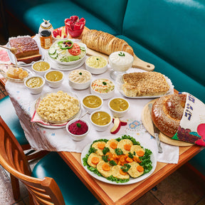 A Feast for Rosh Hashanah with Gefilte fish, mac and cheese, challah, pudding, honey cake, rye bread. From United Bakers on a set table in their rear dining room.